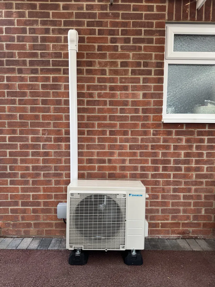 Daikin outdoor unit on anti-vibration feet with white external pipework trunking at the Fareham installation